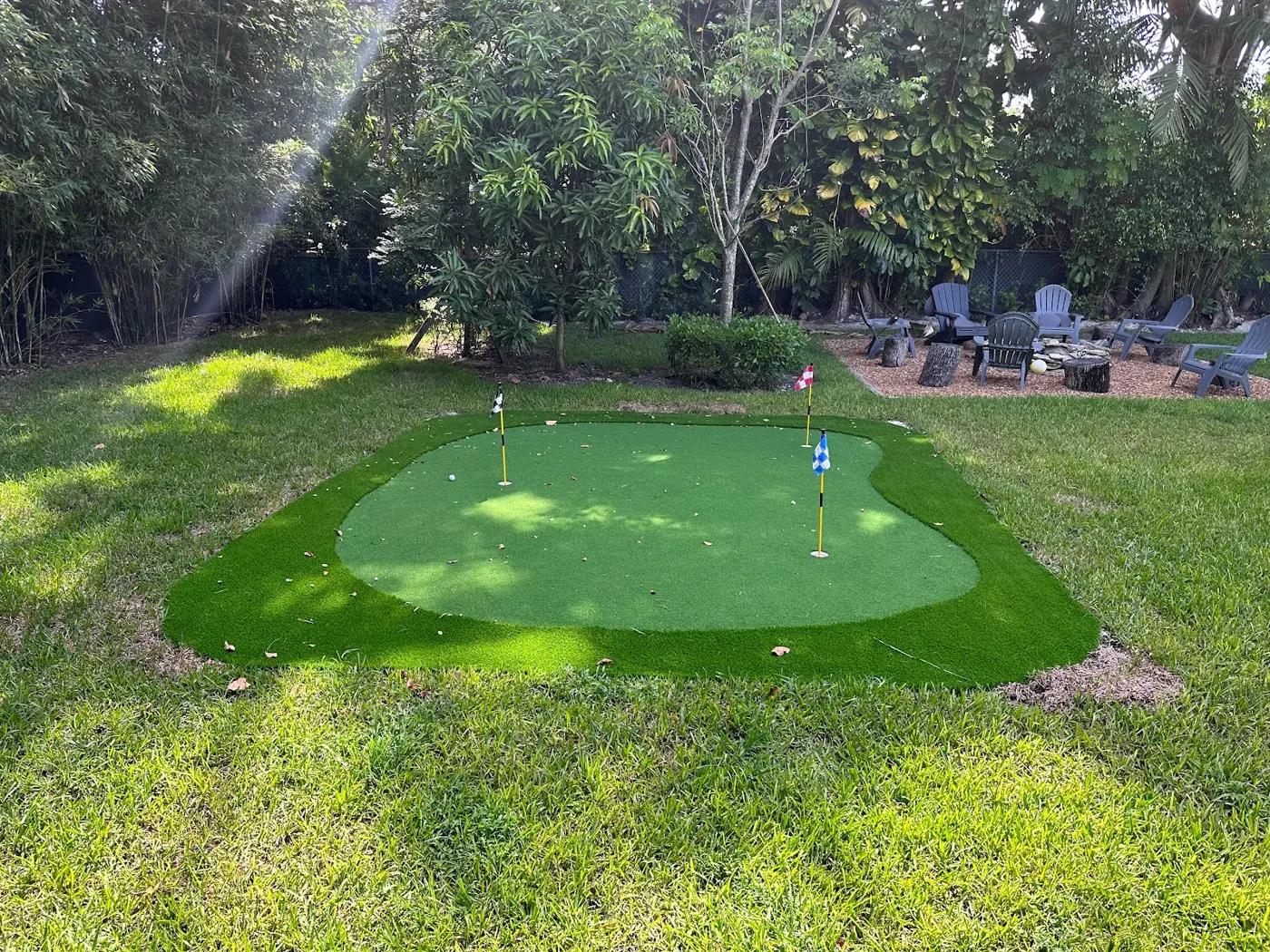 Backyard putting green with three flags