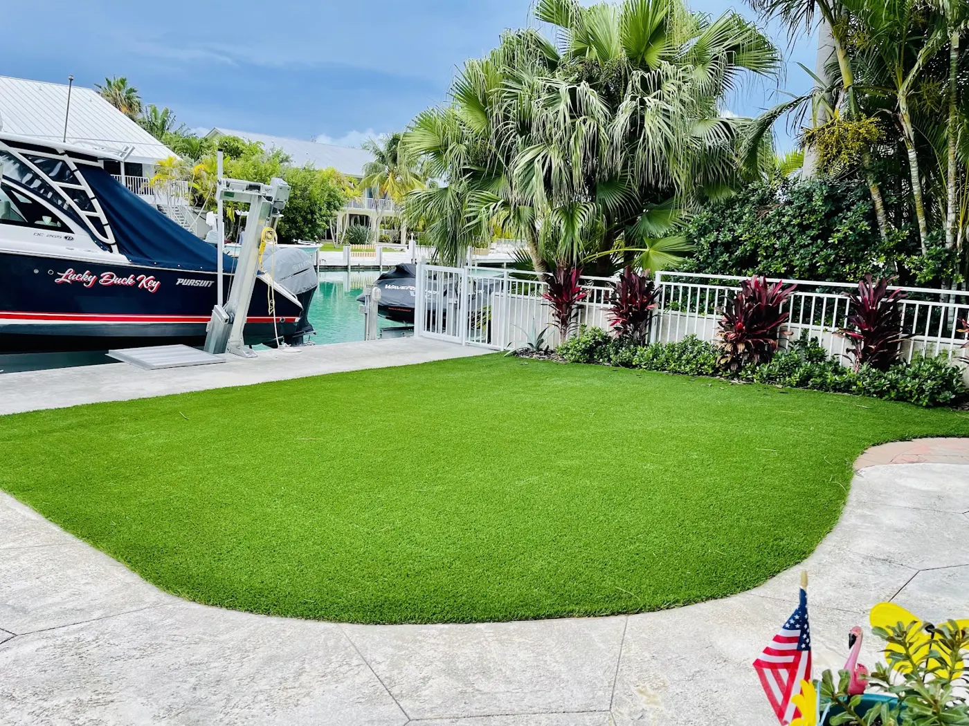 Curved turf lawn beside a dock and boat lift
